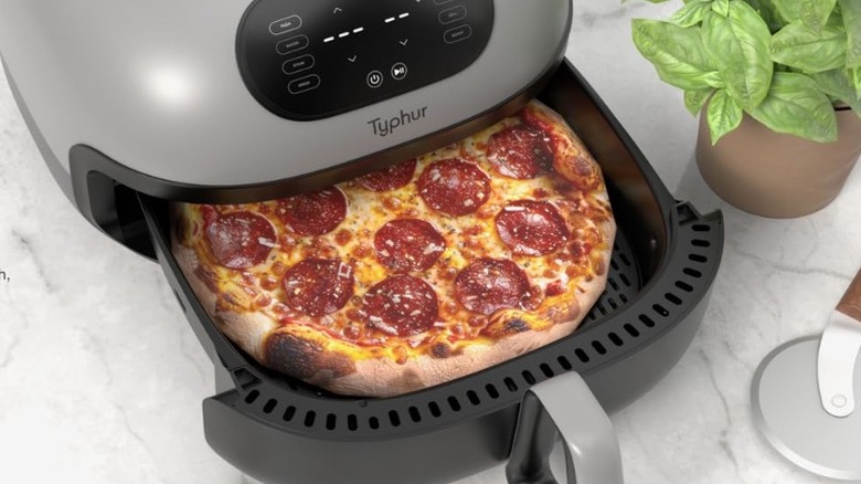 The Typhur Dome 2 air fryer with a perfectly cooked pizza in the tray