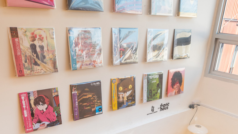 Man putting record on wall for DIY vinyl display