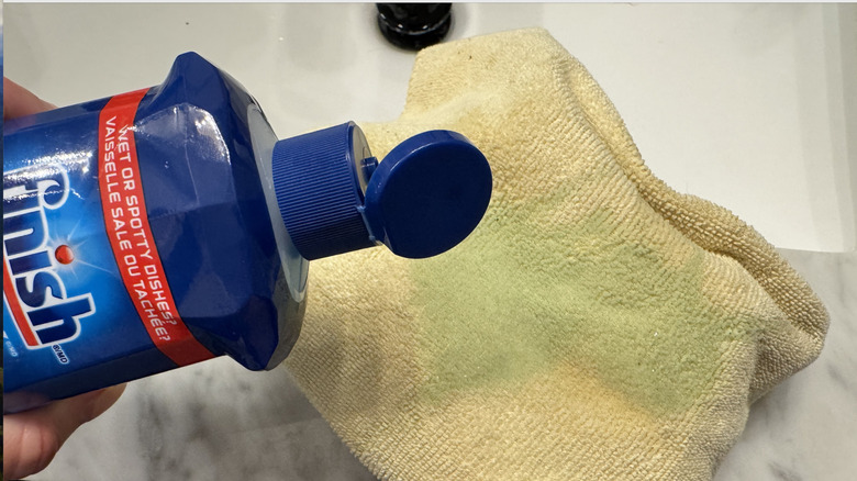 Rinse aid poured onto microfiber cloth