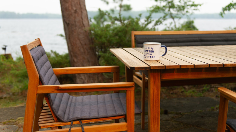 Coffee mug sitting on cottage table outdoors