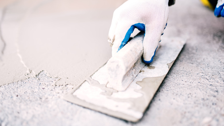 Applying concrete repair compound
