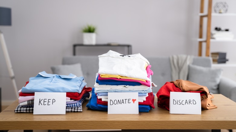 decluttering clothes with categorized stacks