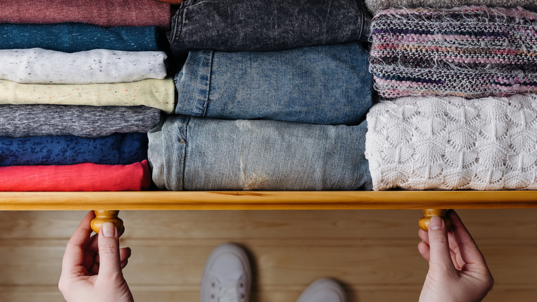 Woman looking through dresser drawer