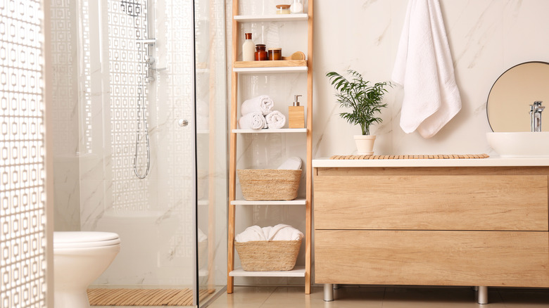 Bathroom with white towels on shelves