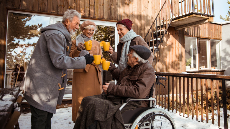 A group of people gather on a patio in winter.