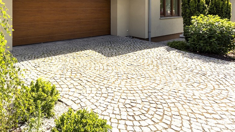 A house with a cobblestone driveway
