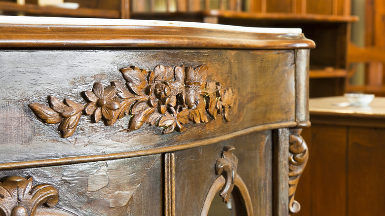 Close up of carved wood furniture in an antique store