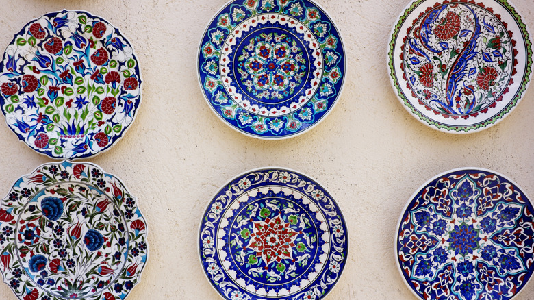 Closeup of six colorful plates hanging on a wall