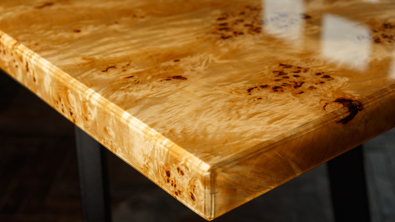 The edge of a burl wood table.