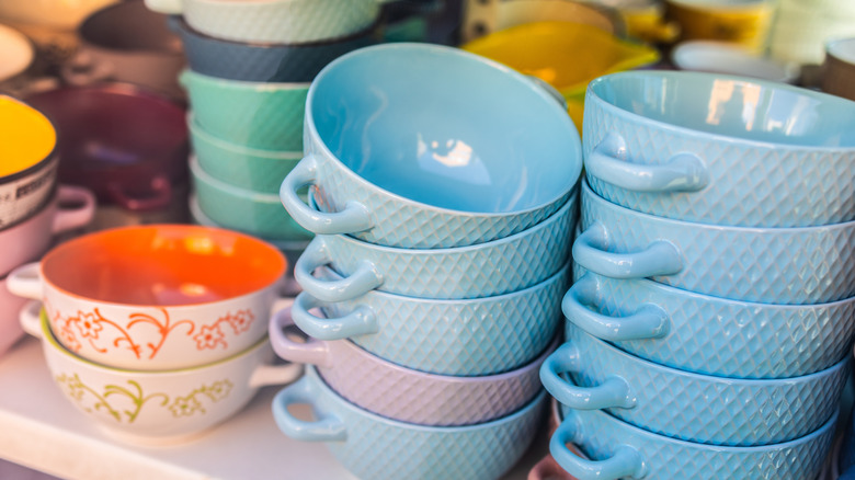 Pastel toned bowls and other servingware at a thrift store.