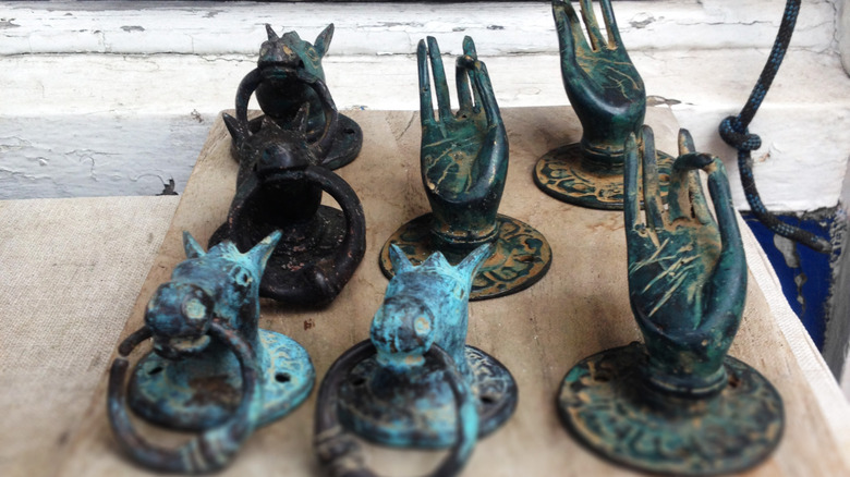 Brass door knockers with natural patina.