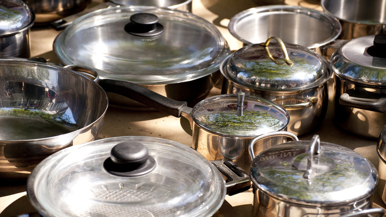 Stainless steel pots for sale at a flea market.