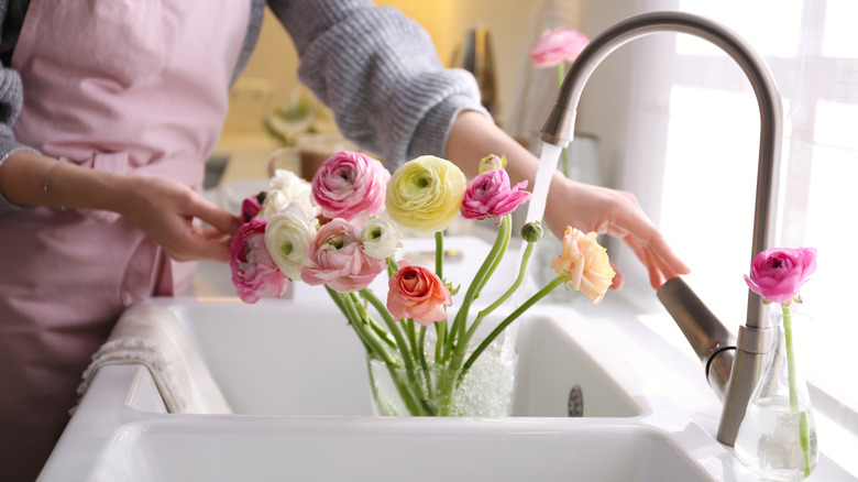 Adding water to flower vase