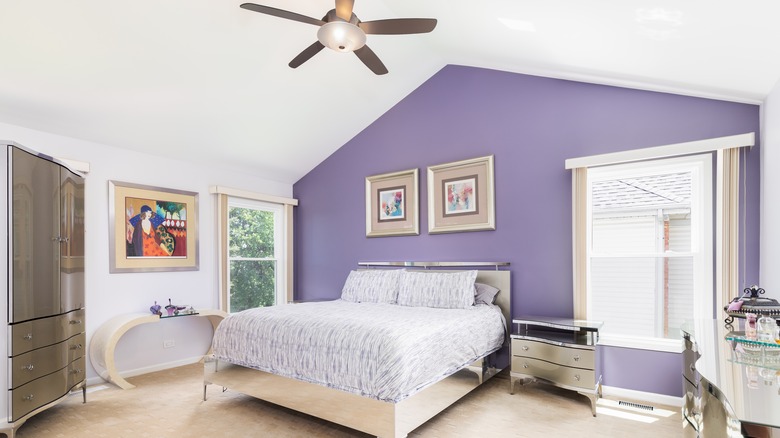 bedroom with purple accent wall