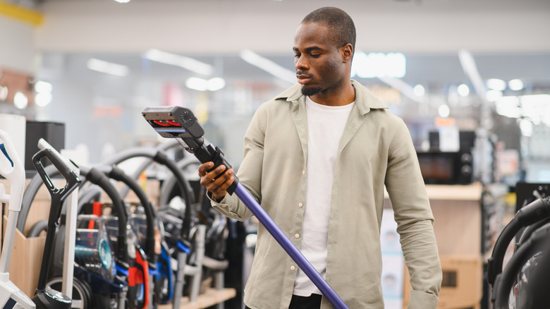 Man looking at vacuums at a store