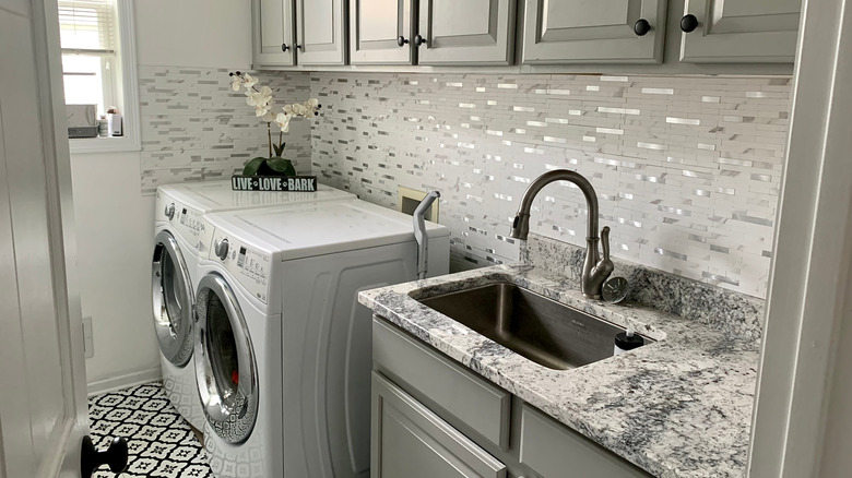 A laundry room with a peel-and-stick back splash