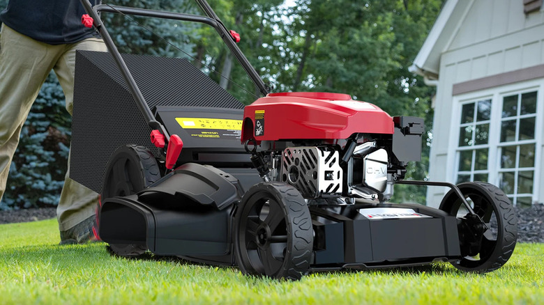 An Amerisun 21-inch gas-powered lawn mower on a green lawn