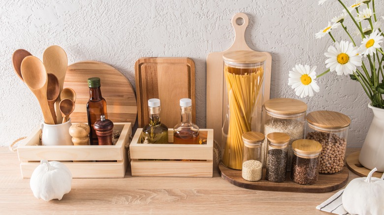A collection of bamboo organizers and kitchen tools on a countertop