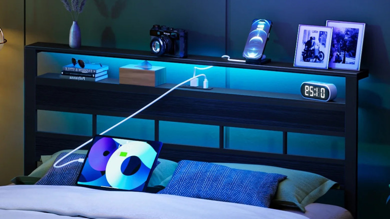close up of bed with wooden head board and blue lighting