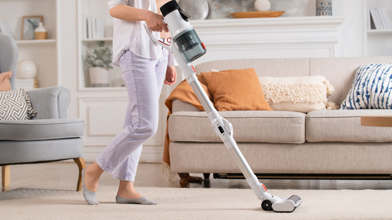 woman using cordless vacuum