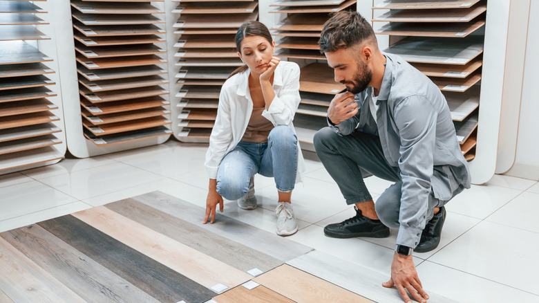 A couple shopping for flooring inside a store