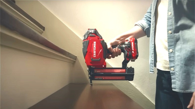 person using Craftsman power nailer