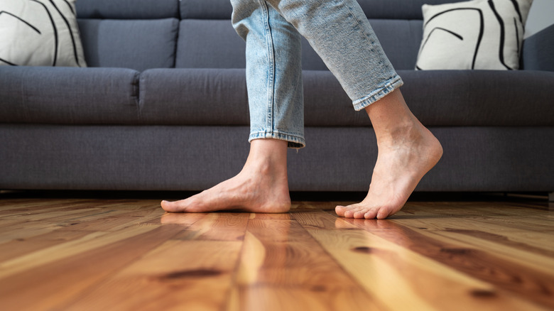 Bare feet walking on wooden floor