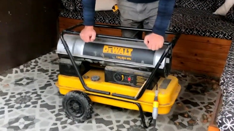 Person moving a DeWalt kerosene heater