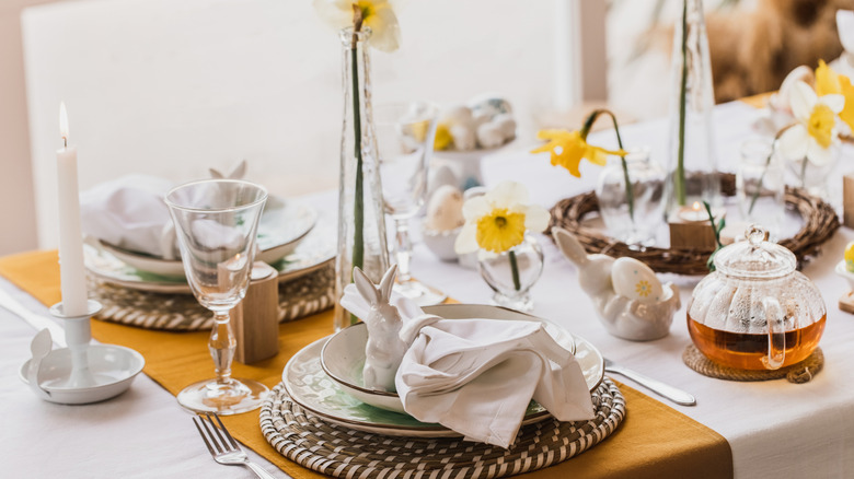 Upscale Easter table setting with tableware and floral centerpieces