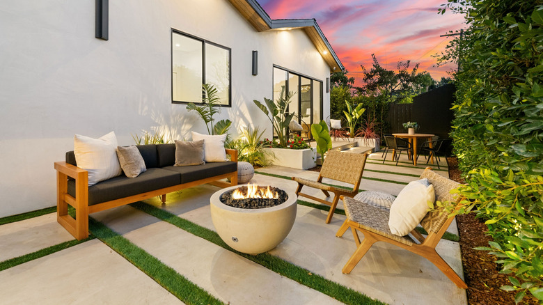 firepit and chairs in backyard during sunset