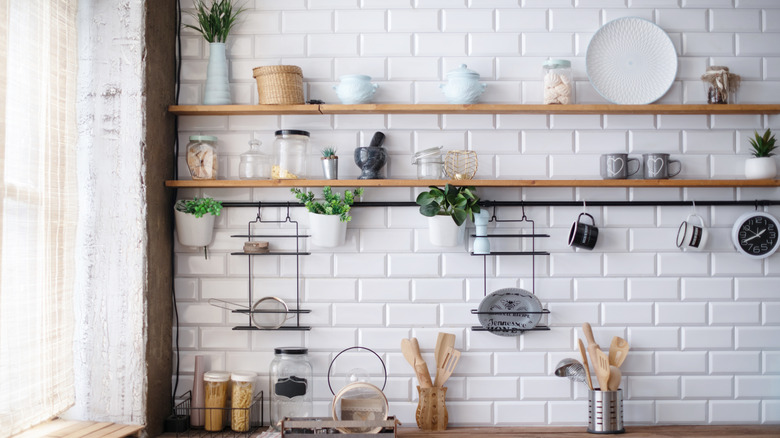 Wooden floating shelves on kitchen wall