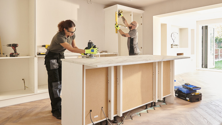 People installing kitchen countertops