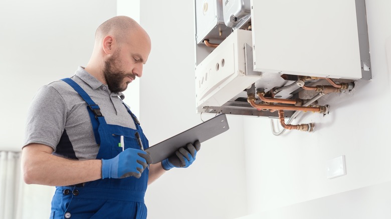 man inspecting gas system