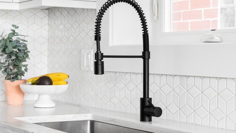 Black faucet in kitchen