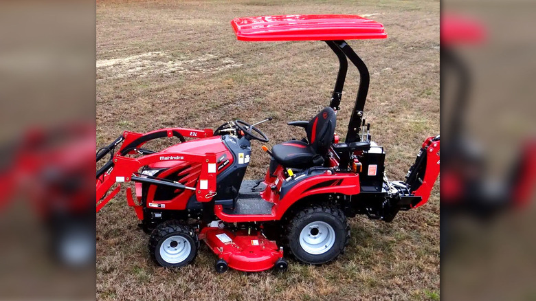 Red Mahindra riding lawn mower with canopy