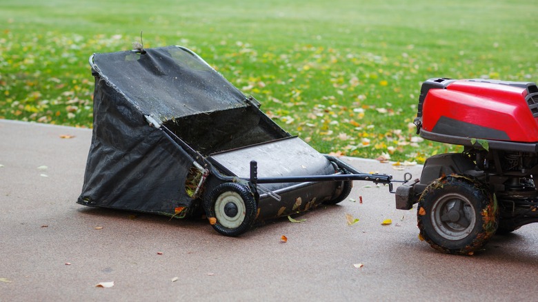 A tow-behind lawn sweeper attached to a mower
