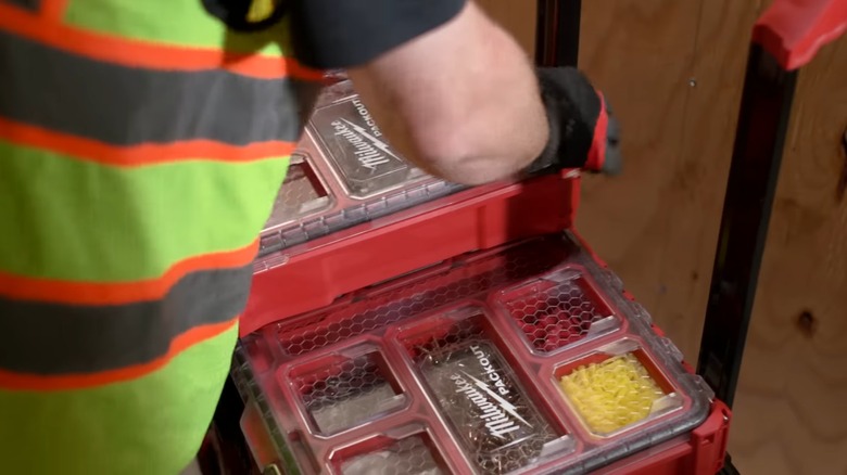 man using milwaukee packout tool boxes