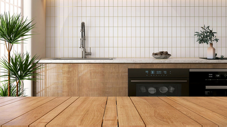 Vertical backsplash in white in a timber kitchen with white counter tops