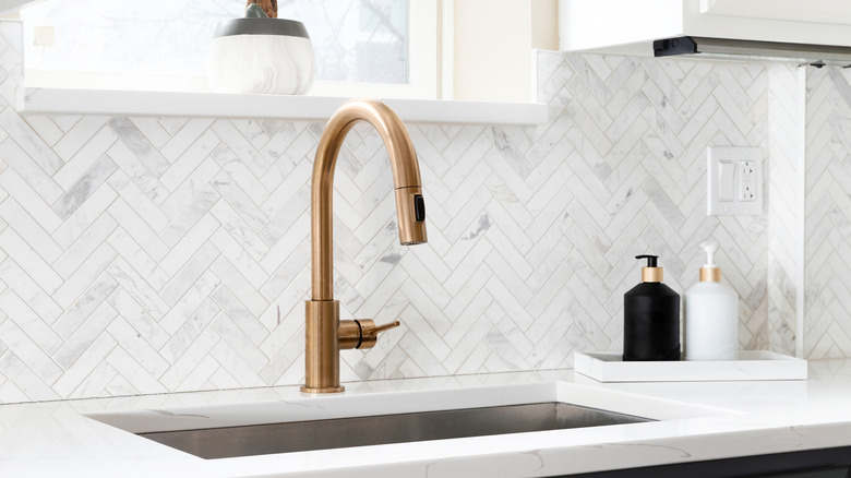 Herringbone white marble backsplash