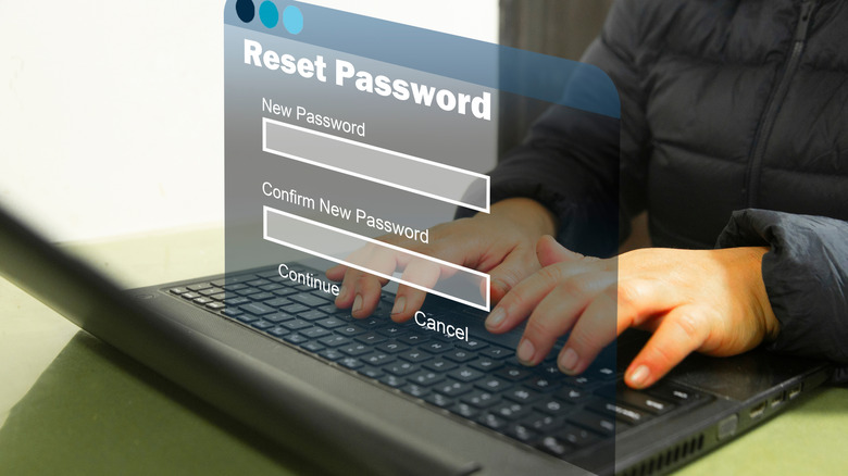 Hands resetting password for a site on a laptop