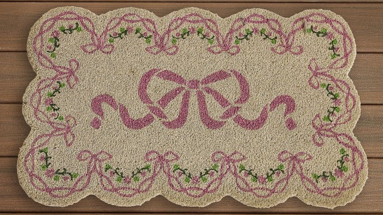 Scalloped-shape LoveShackFancy doormat with pink bows