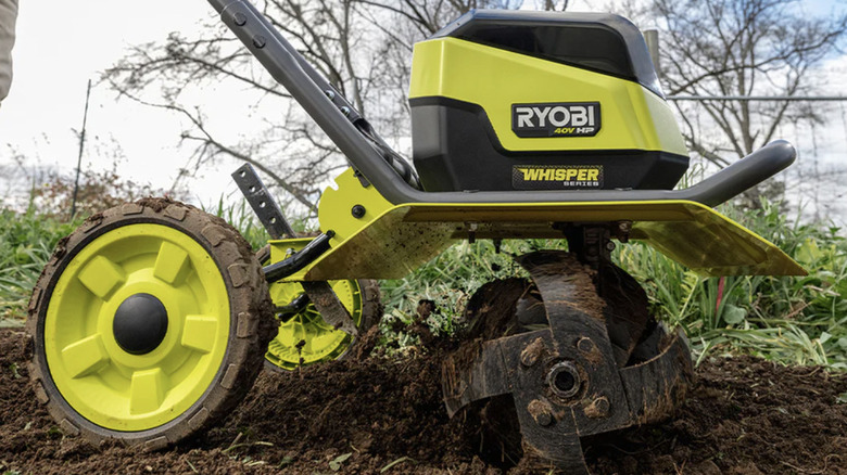 Ryobi's brushless 16-inch front tine tiller working in a garden