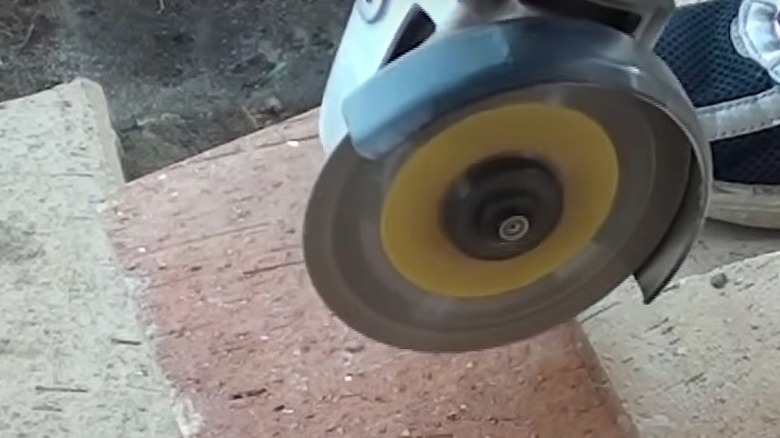 person cutting bricks