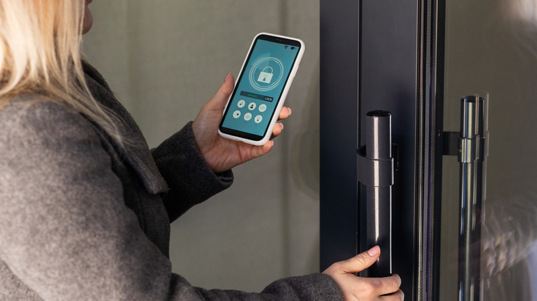 person opening smart door with phone