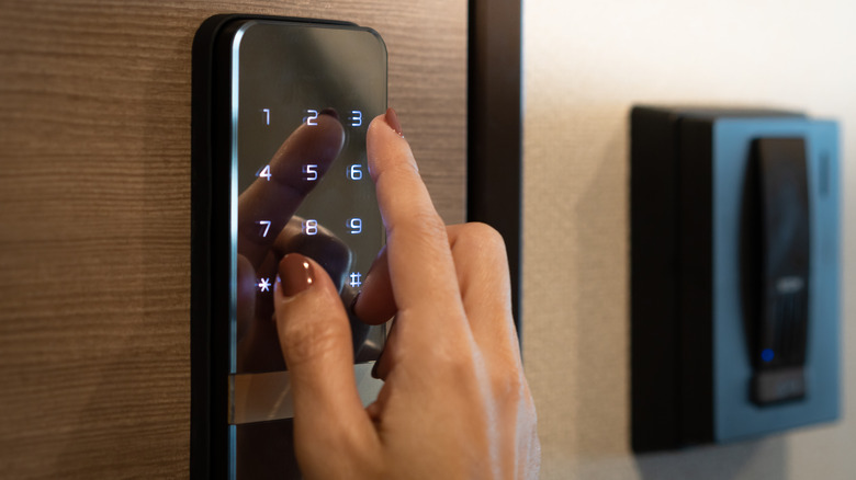 hand using smart lock keypad