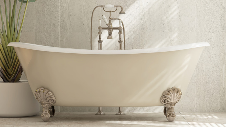 Close up of a white soaking tub silver feet