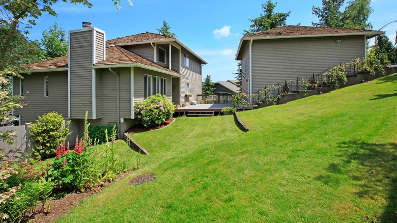 A large house with a sloped yard