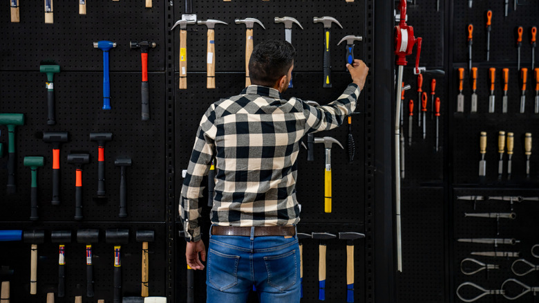 Someone shopping for hammers