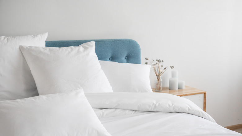 clean bed bedside table pillows