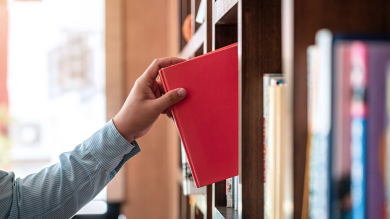 pulling book from shelf